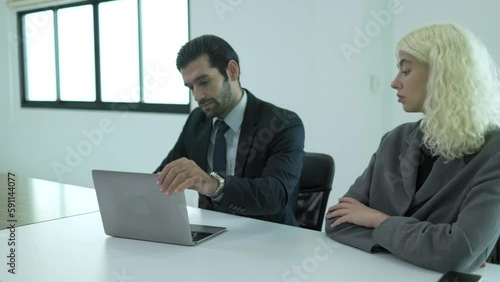 Male supervisor pointing at face, rude, angry, hate speech to female colleague in meeting at office