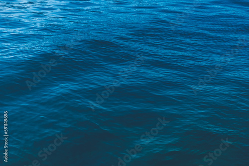Abstract natural background. Azure sea water with ripples on the surface. Сopy space, shot from top © olezzo