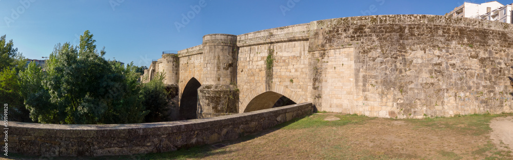 The Old Bridge over Minho River is a medieval footbridge built on Roman foundations in Ourense, Spain.