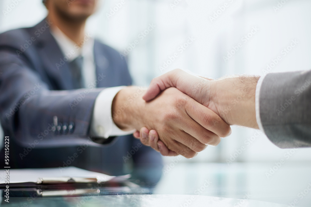 close up.businessman shaking hands with his business partner