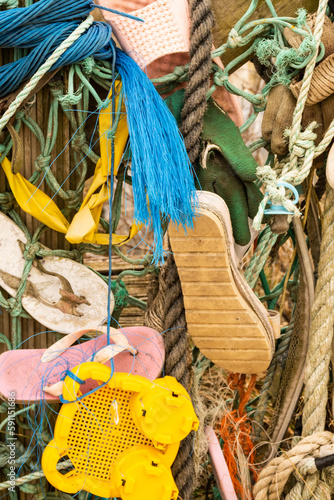 Fotografie random debris items flotsam and jetsam that have washed ashore including lots of plastic pollution that litters the sea harming marine life