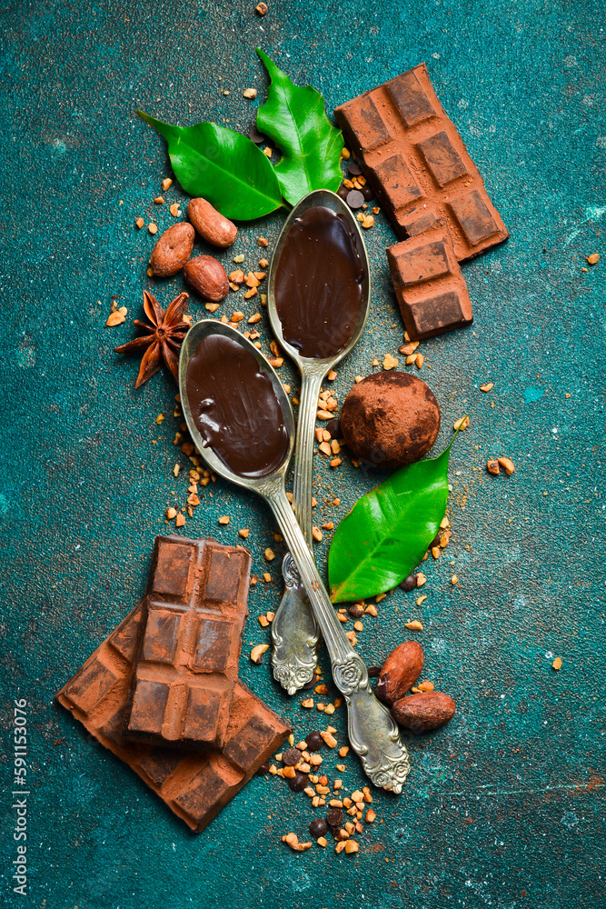 Hot melted chocolate in a spoon. Ground cocoa powder for making chocolate. Cocoa beans. Top view. Hot melted chocolate in a spoon. Ground cocoa powder for making chocolate. Cocoa beans. Top view.