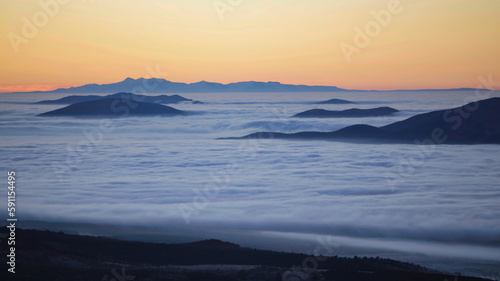 mountains visible in a sea of       clouds