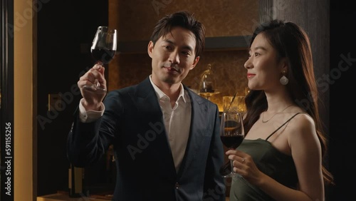 Elegant young couple enjoying red wine,4K