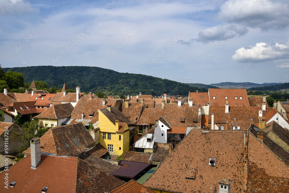 Fototapeta premium Towers and rooftops of medieval city of Sighishoara in Transylvania, Romania. Sighisoara old town in summer. Birthplace of Vlad Dracula.