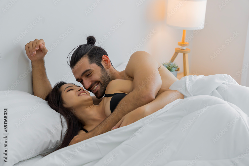 Couple having fun together at home and having sex on the bed in the bedroom at home Couple having fun together at home and having sex on the bed in the bedroom at home