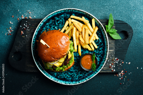 Homemade hamburger and fries with ketchup. Fast food. On a dark background, close-up.