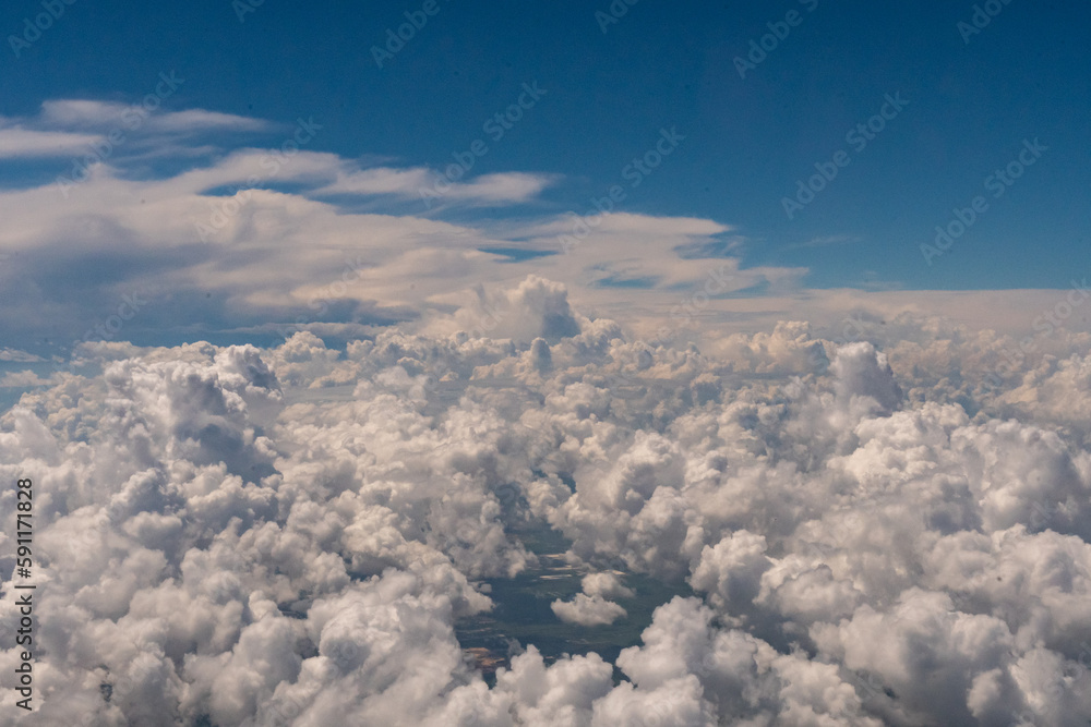Aerial view of the tops of clouds from outside of my airplane window on a cross country flight from Houston, Texas to Los Angeles, California