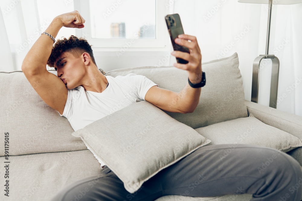 man interior lifestyle freelancer blogger couch selfies smartphone using home cellphone laptop man interior lifestyle freelancer blogger couch selfies smartphone using home cellphone laptop