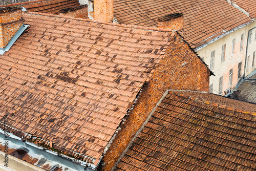 Tile rooftops in old medieval town. Ancient city from above with red tiling roofs. European architecture