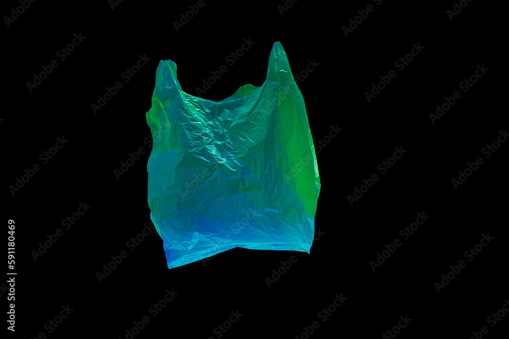 Fototapeta premium colored green and blue plastic bag fly on black background