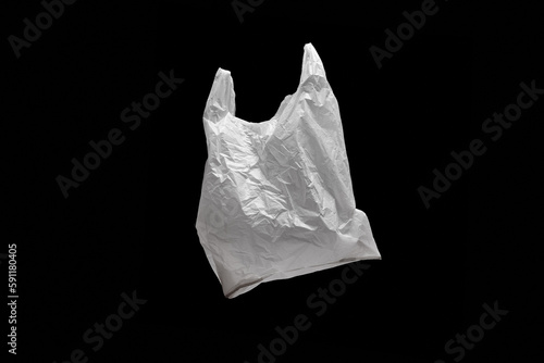 one white plastic bag on black background, color, horizontal, minimalistic 
