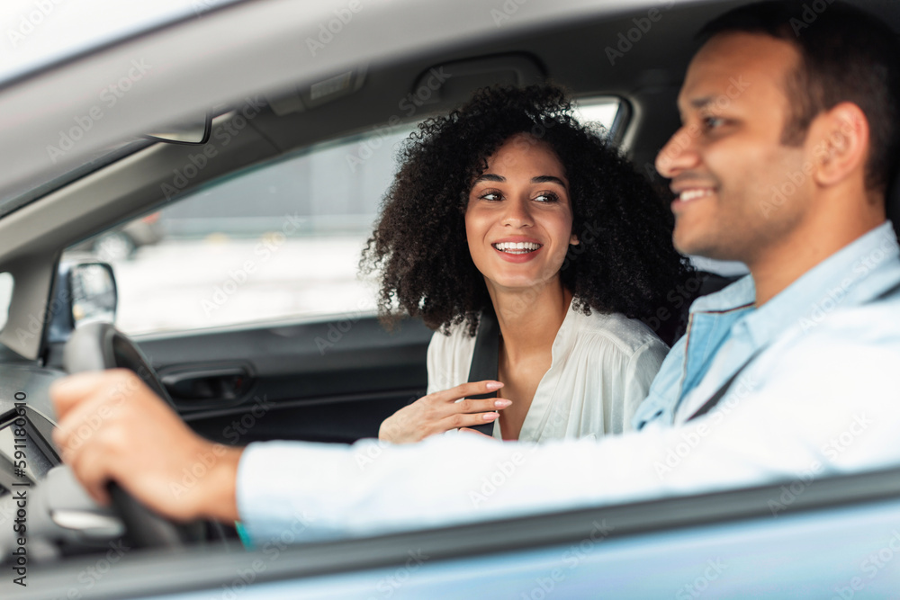 Cheerful Arabic Couple Enjoying Car Ride Sitting Inside, Side View Cheerful Arabic Couple Enjoying Car Ride Sitting Inside, Side View