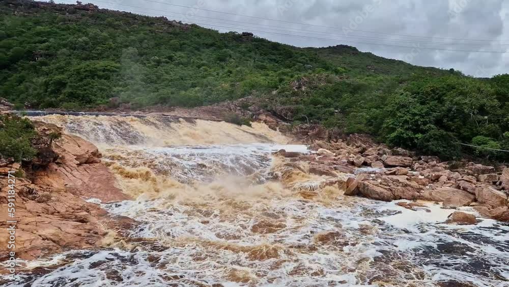 Donana Waterfall in Paraguassu River with dark waters due to iron ore in Andarai, Chapada Diamantina, Bahia in Brazil Donana Waterfall in Paraguassu River with dark waters due to iron ore in Andarai, Chapada Diamantina, Bahia in Brazil
