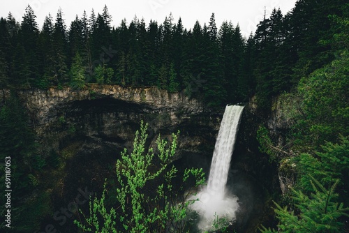 Aerial shot of Brandywine Falls Provincial Park with evergreen trees around a waterfall