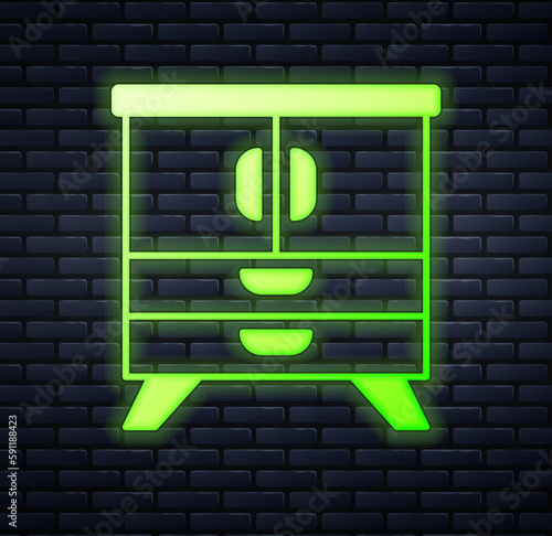 Glowing neon Chest of drawers icon isolated on brick wall background. Vector