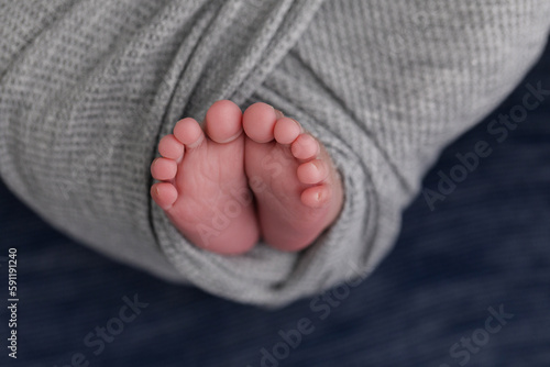 baby feet wrapped in grey 
