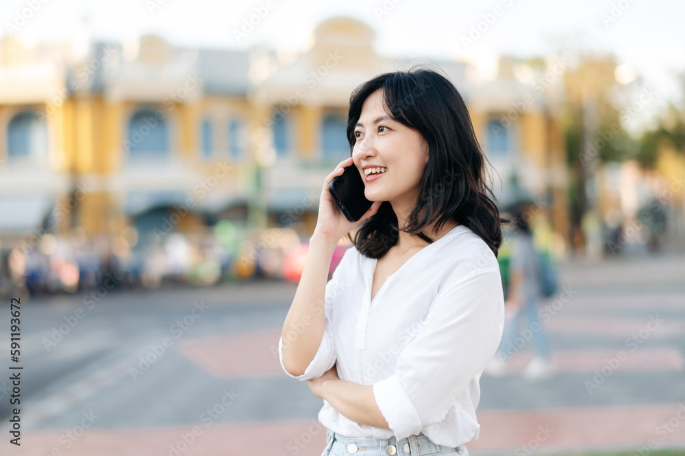 Portrait beautiful young asian woman with smart mobile phone around outdoor street view in a summer day Portrait beautiful young asian woman with smart mobile phone around outdoor street view in a summer day