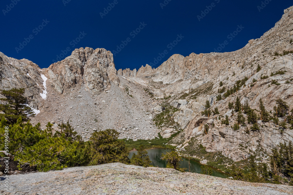 Mountain lake with distant Mt Whitney and deep blue sky