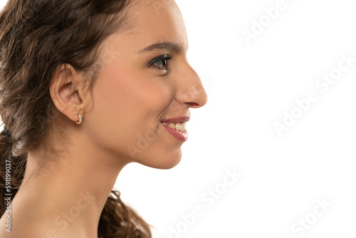 Photography Profile portrait of a beautiful smiling young woman, a nose with a hump on white