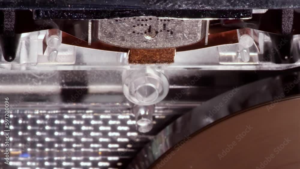 A macro top view of a playback head cassette tape. An analog tape recording format for