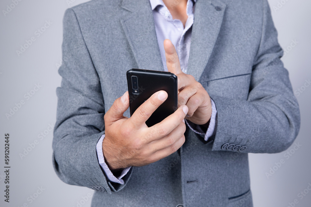 phone.men hand holding texting using mobile on sofa at home phone.men hand holding texting using mobile on sofa at home
