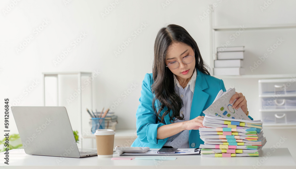 Business woman using calculator for do math finance on wooden desk in office and business working background, tax, accounting, statistics and analytic research concept..