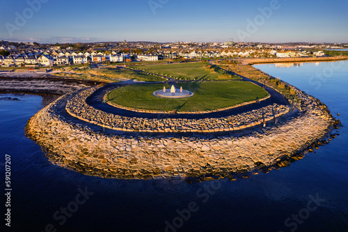 Aerial view on Famine Ship Memorial in Celia Griffin Memorial Park in Salthill area of Galway city, Ireland. Dense residential area in the background.