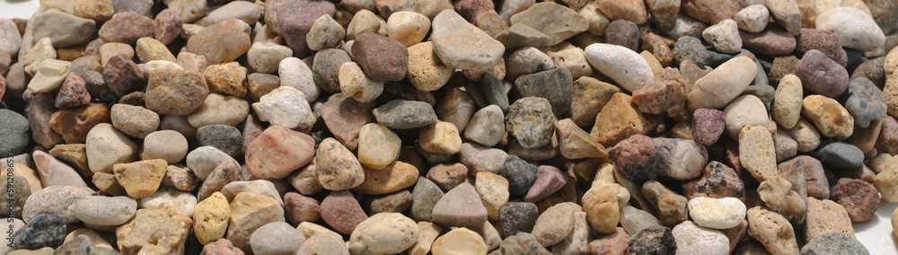 Background of many little dark, brown and yellow stones close up view Background of many little dark, brown and yellow stones close up view