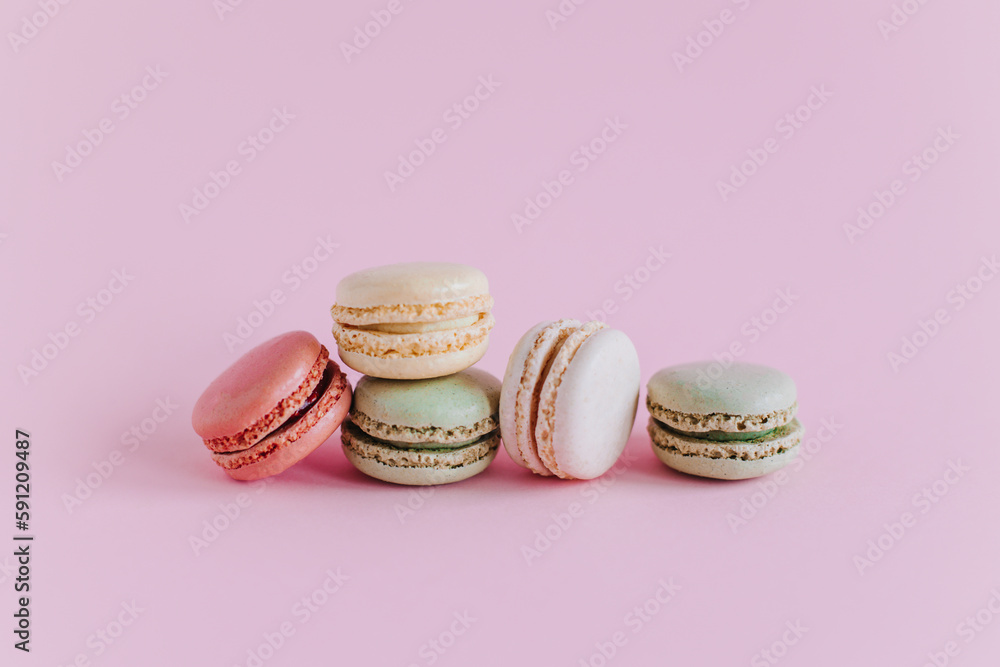 Tasty french macarons on a pink pastel background. Tasty french macarons on a pink pastel background.