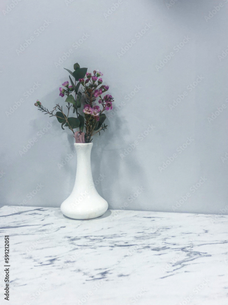 Bouquet of purple flowers in vase on table