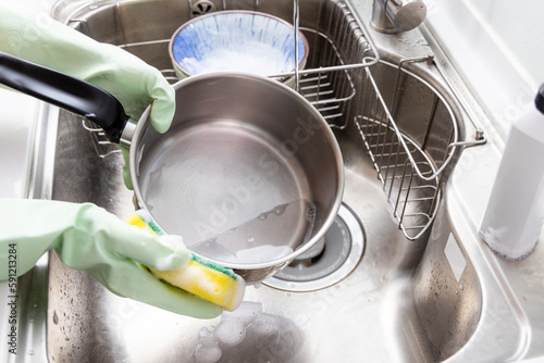 Woman wash dish in the kitchen