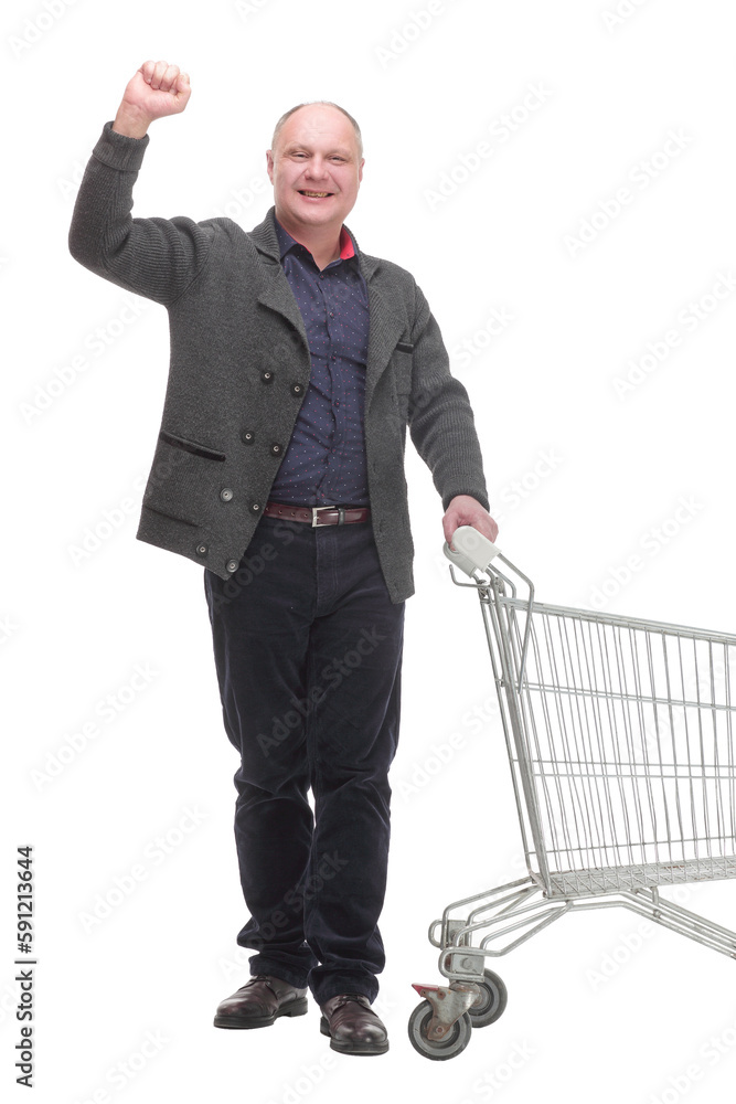 smiling casual man with shopping cart .isolated on a white background. smiling casual man with shopping cart .isolated on a white background.