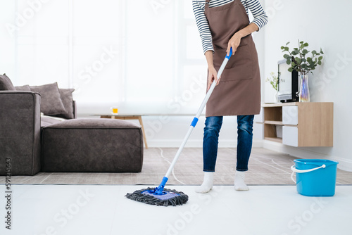 Tableau sur toile People, housework and housekeeping concept - Happy Asian woman or housewife with mop cleaning floor in living room at home