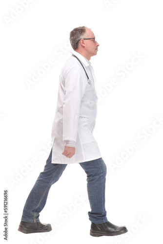 Middle age male doctor walking away and look at camera isolated on white