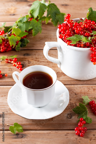 Natural vitamin tea with fresh red currant berries, summer fruit harvest
