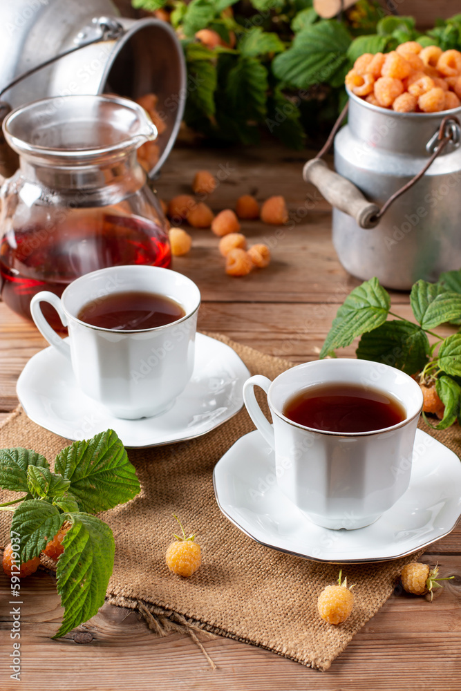 Flavored raspberry tea. Vitamin hot steaming drink with natural berries on wooden table Flavored raspberry tea. Vitamin hot steaming drink with natural berries on wooden table