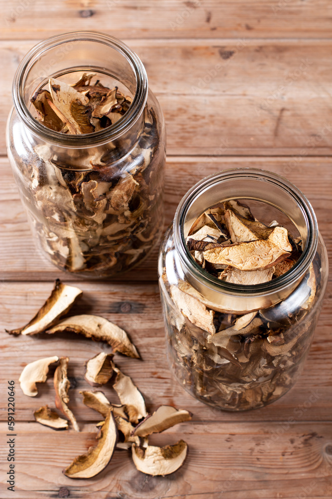 Dried mushrooms. Mushrooms in jar on the wooden table Dried mushrooms. Mushrooms in jar on the wooden table