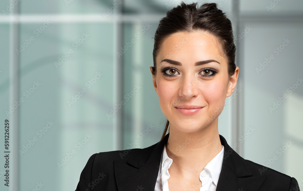 Smiling businesswoman portrait in a modern office Smiling businesswoman portrait in a modern office
