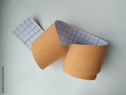 kinesiology tape on white background. Physiotherapy and therapeutic tape for wrist pain, aches and tension. elastic therapeutic tape. adhesive tape and alternative medicine

