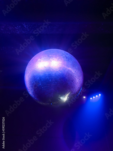 disco ball illuminated by blue light in a night club