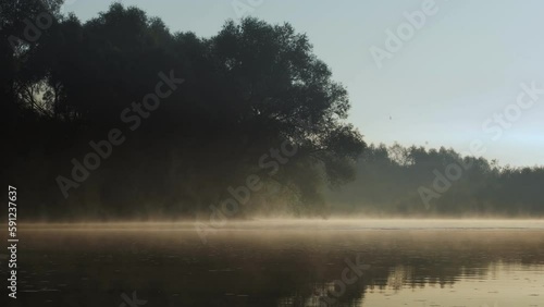 Morning water vapor over the river, fog over the water. Calm dawn on the river.