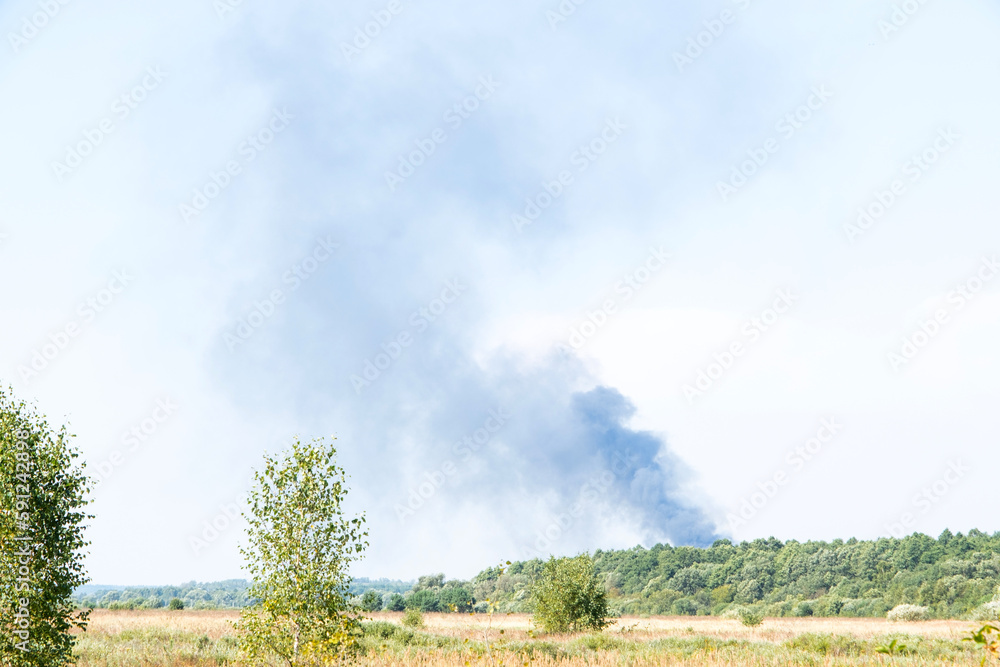 A forest fire from the heat in summer is black smoke. Spring grass fell - grass fires. Danger of village fire A forest fire from the heat in summer is black smoke. Spring grass fell - grass fires. Danger of village fire