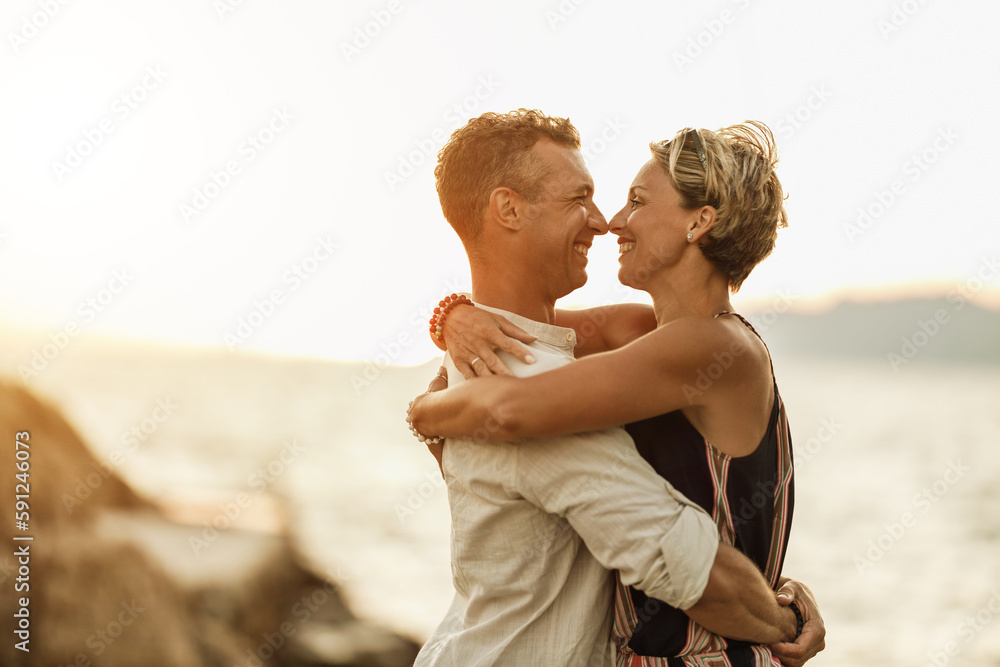 Couple In A Hug Enjoying A Summer Vacation At The Beach