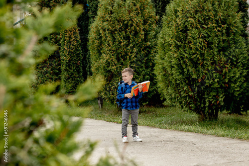 Little first grader with backpack looking the copybook, going home from school © volody10