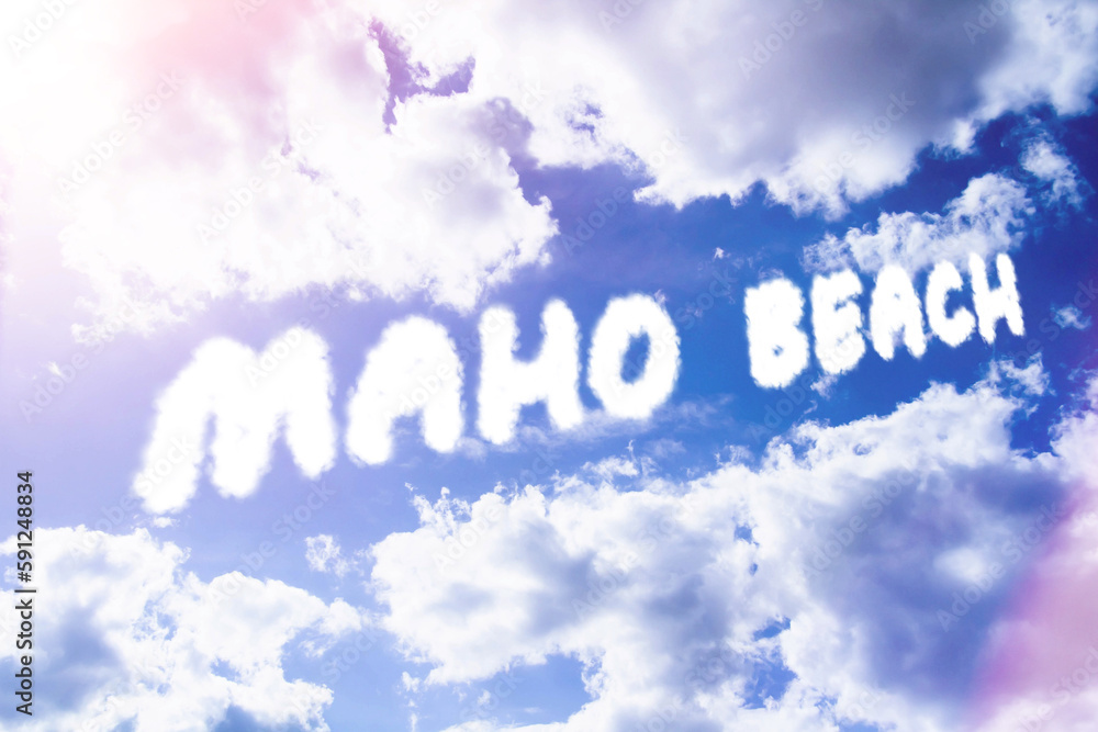 Fototapeta premium Maho beach. Text from clouds in sky in bright sunlight.
