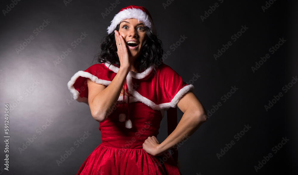 Happy excited young woman in santa claus hat Happy excited young woman in santa claus hat