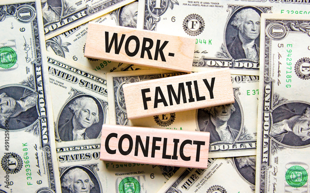 Work-family conflict symbol. Concept words Work-family conflict on wooden block on a beautiful background from dollar bills. Dollar bills. Business work-family conflict concept. Copy space.