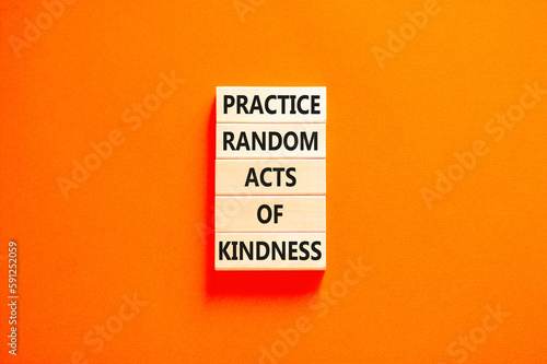 Practice random kind of kindness symbol. Concept words Practice random kind of kindness on wooden block. Beautiful orange table orange background. Business practice kindness concept. Copy space.