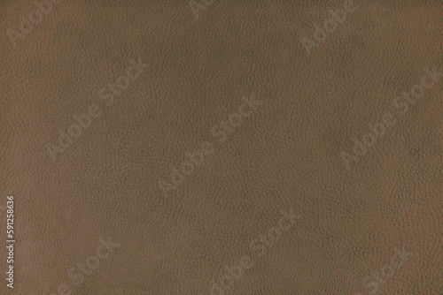 Texture background of brown velours fabric textured like leather surface. Fabric texture close up of upholstery furniture textile material, design interior, wall decor, backdrop, wallpaper.
